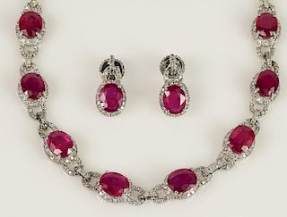 Lady's 21 Large Oval Brilliant Cut Ruby and 14 Karat White Gold Necklace and Earring Suite accented throughout with small Round Brilliant Cut Diamonds