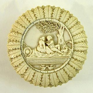 Antique Miniature Continental Carved Ivory Box. Finely carved romantic scene set in foliate motif. Unsigned. Good condition. Measures 2-3/4" dia. This