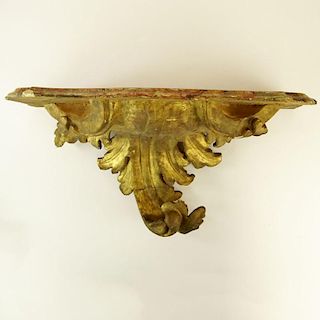 Early 19th Century Carved Parcel Gilt Wood Hand painted Faux Marble Console. Unsigned. Old repair, rubbing and surface losses. Measures 14" H x 26" W 