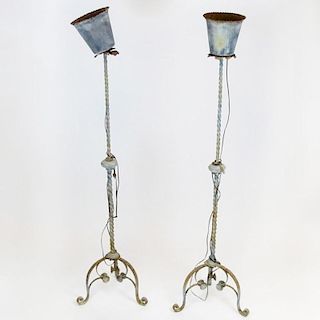 Pair circa 1920's Wrought Iron Torchieres. Unsigned. Corrosion throughout. Please examine care fully prior to bidding. Measures 73-1/2" H x 18" W at b