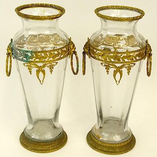 Pair of Gilt Metal Mounted Glass Vases With Mask Ring Handles. Unsigned. Oxidation or in good condition. Measures 8-3/4" H x 4" W. Shipping $38.00
