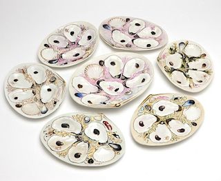 A group of 7 hand-painted porcelain oyster dishes