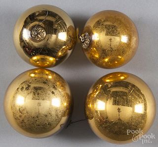 Four yellow kugel ornaments, two - 3 1/4'' dia. and two - 3 3/4'' dia.