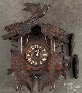 Black Forest carved cuckoo clock with a bird crest, 22'' h.