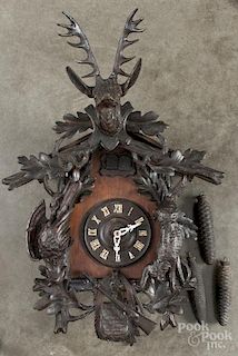 Black Forest carved cuckoo clock with a stag crest, 31 1/2'' h.