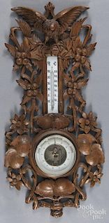 Black Forest carved barometer/thermometer, 20th c., with an eagle crest, 28'' h.