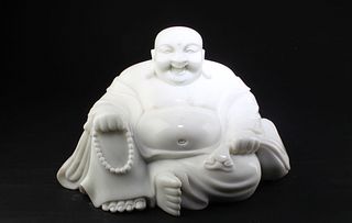 A Carved Stone 'Smiling Buddha' Statue
