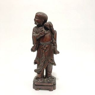 A Carved Wooden Figurine. Height: 18.6 cm