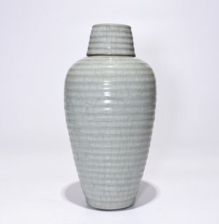 A LongQuan Jar with lid. A four character mark is imprinted at the base. Height: 26.5 cm