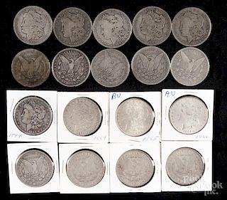 Thirteen Morgan silver dollars, to include four 1884, two 1884 O, six 1885, and an 1886, G-AU.