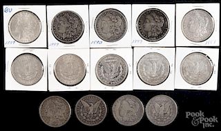 Fourteen Morgan silver dollars, to include an 1887, an 1887 O, three 1889, four 1889 O, two 1890