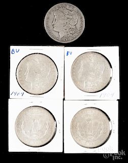 Five Morgan silver dollars, to include a 1904, VG, and four 1904 O, VF-XF.
