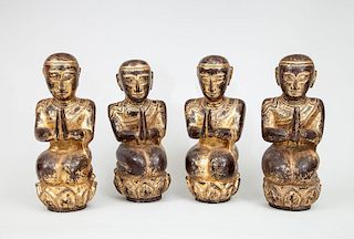 Four Thai Carved, Painted and Parcel-Gilt Hardwood Seated Figures of Buddha