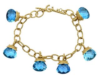 18 Karat Gold Bracelet, having six blue topaz drops, 7 inches, total weight 32 grams.