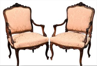 Pair of Louis XV Style Walnut Open Arm Chairs, having custom upholstery, height 40 inches.