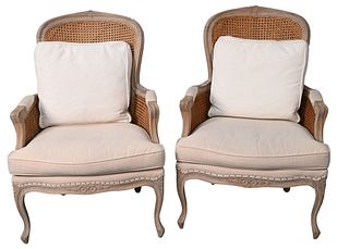 Pair of Louis XV Style Fauteuil, having upholstered seats with caned backs and sides, height 40 inches, width 27 inches.