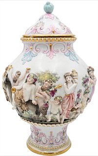 Porcelain Urn With Cover, having three dimensional figures, chips on base and cover, height 16 inches.