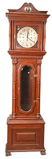 Seth Thomas Mahogany Tall Clock, having columns, carving, and paw feet; has weights, height 88 inches, width 25 inches.