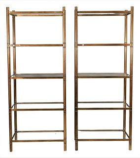 Pair of Brass Etereges, each having five tiers and glass shelves, in the manner of Masen Jansen, height 80 inches, width 32 inches, depth 17 inches.