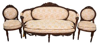Three Piece Louis XVI Style Salon Set, having carved backs and rams head hand rests, with loose cushion seats (chips on wing of bird), settee length 6