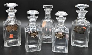 Five Baccarat Crystal Decanters, four square and one octagon, one square with large chips, tallest height 9 inches.