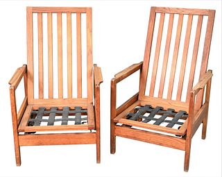 Pair of Oak Modern Rocking Chairs, having slat back with spring rocking mechanism, height 44 inches.