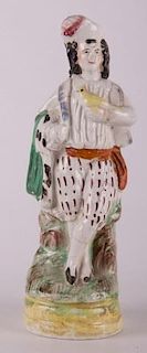 Staffordshire Scotsman and Bird Figurine