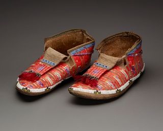 A pair of Sioux beaded and quilled hide moccasins