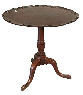 Chippendale Mahogany Tip Table, having pie crust top on urn turned shaft set on tripod base, height 26 3/4 inches, diameter 29 3/4 inches.
