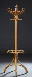 French Bentwood Hall Tree, c. 1900, the ring turned finial over eight bentwood coat and hat hooks, on a reeded support, above bentwood scrolled cane a