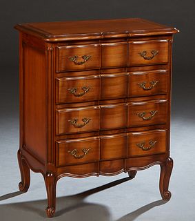 Diminutive French Louis Philippe Carved Cherry Commode, 20th c., the ogee edge serpentine bowfront top over a bank of four drawers, on scrolled cabrio