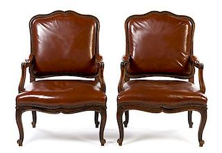 A Pair of Louis XV Walnut Fauteuils Height 39 inches.
