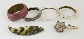 Six Pieces of Alexis Bittar Lucite Jewelry, 20th c., consisting of three hinged bangle bracelets, an octagonal flat slave bracelet, a large leaf form 