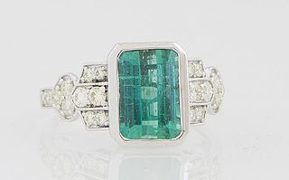 Lady's 18K White Gold Dinner Ring, with a 3.51 ct. emerald cut green tourmaline, flanked by diamond mounted lugs and shoulders of the band, total diam