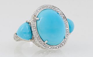 Lady's 14K White Gold Dinner Ring, with a central large oval cabochon turquoise atop a border of round diamonds, with diamond mounted edges, flanked b