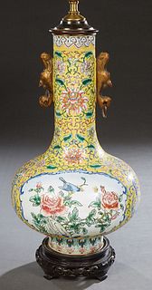 Chinese Porcelain Bottle Form Enamel Vase, early 20th c., with reserves of birds and flowers, on a yellow ground, now mounted on a carved mahogany bas