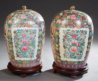 Pair of Large Chinese Porcelain Famille Rose Baluster Form Lidded Jars, 20th c., with floral decoration overall and floral and interior reserves, the 