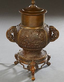 Japanese Patinated Bronze Urn, early 20th c., of baluster form, the sides with pierced integral ring handles flanking a relief panel of a dragon on on