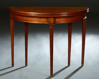 French Louis XVI Style Carved Cherry Demilune Games Table, 20th c., the ogee edge D-top over a wide skirt, on tapered reeded ormolu mounted square leg
