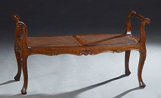 Louis XV Style Carved Beech Double Bench, 20th c., the turned handled sides over a caned seat on cabriole legs, H.- 22 1/4 in., W.- 41 1/2 in., D.- 16