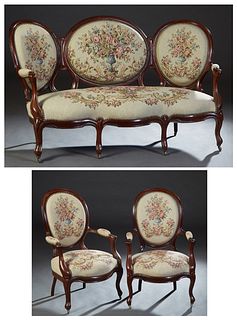 French Louis Philippe Three Piece Carved Cherry Parlor Suite, late 19th c., consisting of a settee and two fauteuils, the triple upholstered medallion