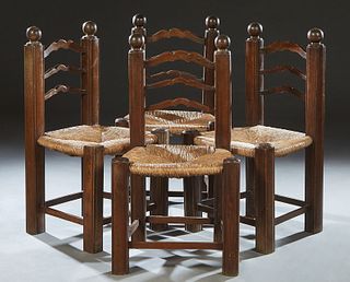 Set of Four French Provincial Carved Oak Rush Seat Dining Chairs, 19th c., the arched ladder back topped by large ball finials, to a bowed trapezoidal