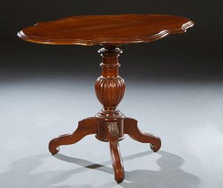 French Louis Philippe Carved Walnut Lamp Table, 19th c., the rounded edge tortoise top on a reeded urn support, to tripodal leaf carved cabriole legs,