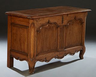 French Louis XV Style Carved Oak Coffer, 19th c., the stepped rounded edge top over a setback front panel with two fielded arched panels flanking a re