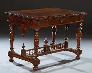 French Henri II Style Carved Oak Writing Table, c. 1880, the stepped sloping carved edge top over a wide skirt with a long frieze drawer, on turned ta