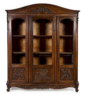 * A Louis XV Provincial Style Walnut Bibliotheque Height 100 x width 79 x depth 19 inches.