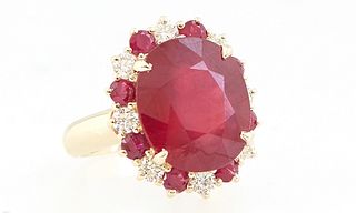Lady's 14K Yellow Gold Dinner Ring, with a large oval ruby atop a border of round diamonds alternating with round rubies, total ruby wt.- 11.25 cts., 