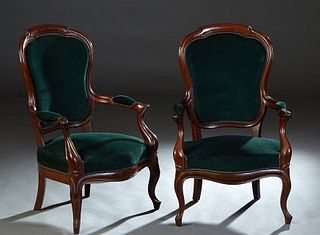 Pair of Louis Philippe Carved Walnut Fauteuils, 19th c., the arched canted shield shaped back to upholstered arms flanking a bowed seat, on curved poi