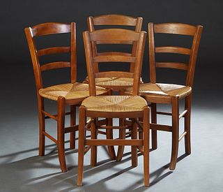 Set of Four French Provincial Carved Beech Rush Seat Dining Chairs, 20th c., the tapered canted ladder back over a woven rush seat, on tapered square 
