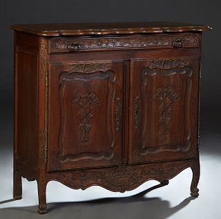 French Provincial Louis XV Style Carved Oak Sideboard, early 20th c., the stepped edge serpentine top over a setback long frieze drawer, above double 